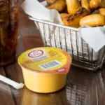 3.8 oz. Microwavable Cheddar Cheese Sauce Cup - 30/Case - Image 3